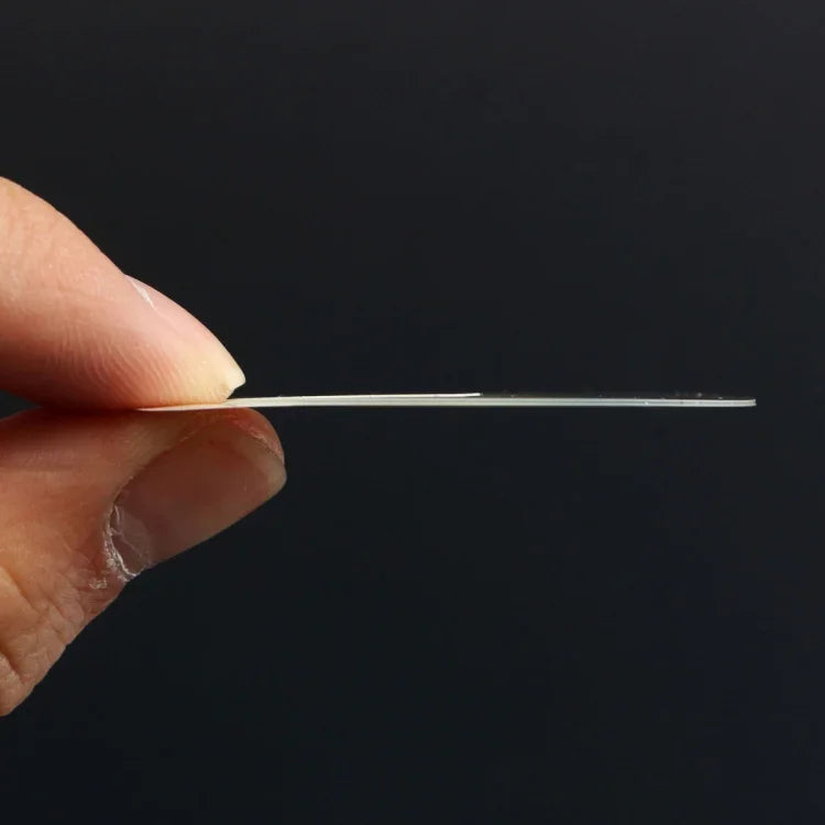 0.26mm tempered glass screen protector for smartwatches shown in hand, highlighting its ultra-thin design.